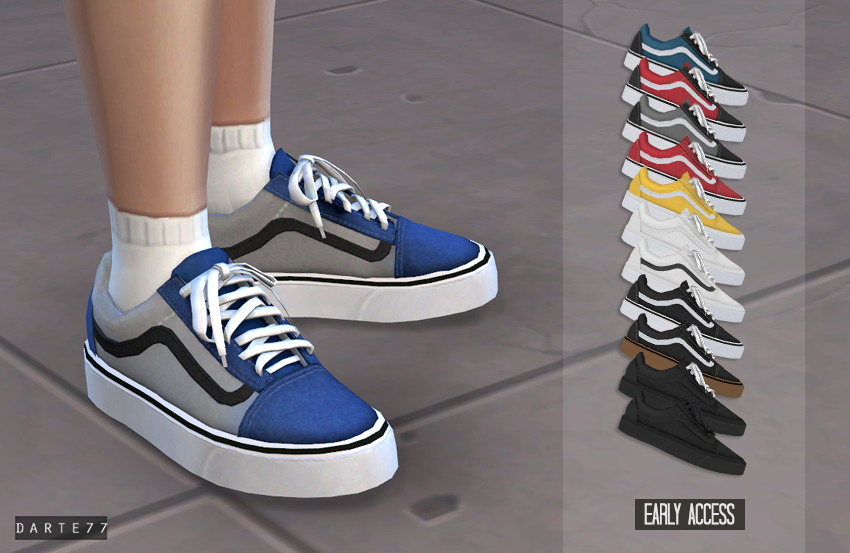 A pair of legs with a pair of blue vans sneakers tied into bows with white socks 