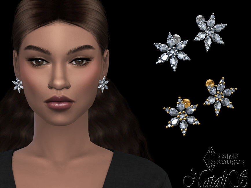 A sim with brown hair and brown eyes who is wearing a pair of large sims 4 cc Christmas snowflake earrings. 