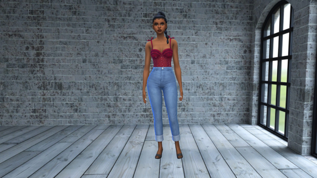 A sim in high waisted blue jeans and a red corset bodysuit with their hair in a braid. The sims 4 cas background for this one is a grey plank floor with grey brick wall behind them.