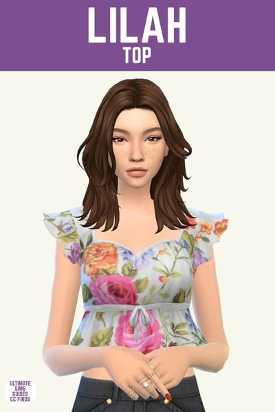 This image has a purple bar at the top with white text that says "Lilah Top" and below is a sim with shoulder length brown hair wearing a cropped floral top with cap sleeves 