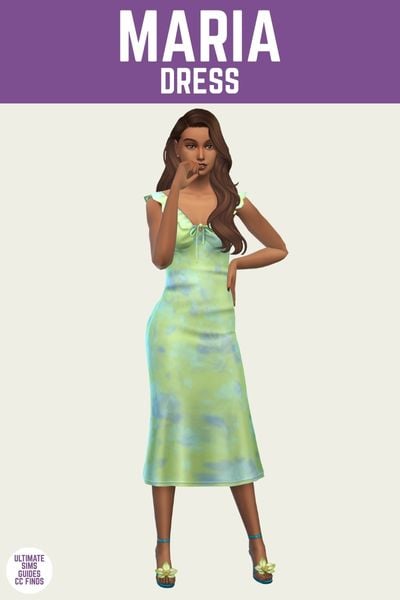 This is a product image for an item from The Orquídeas Set by Serenity. At the top there is a purple bar with white text that says "Maria Dress" and below is a sim posed. They are wearing a blue and green water colour dress with blue shoes 
