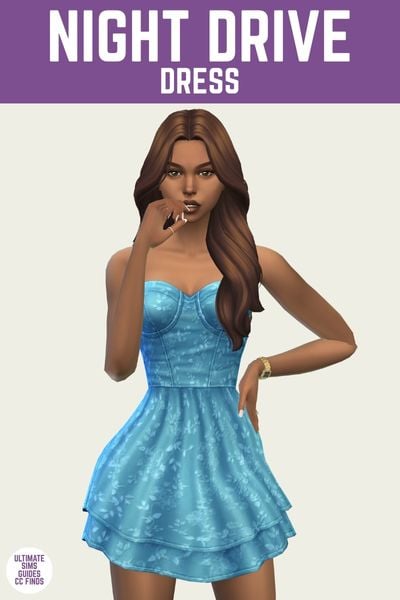 This is a product image for a dress by Trillyke. The image has a purple bar at the top with white text that says "night drive dress" and the sim below is wearing a strapless blue dress with a two layer skirt and a blue flower design 