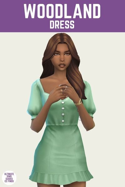 This is a product image for a dress by Trillyke. The image has a purple bar at the top with white text that says "Woodland Dress" and below is a posed sim. The sim is wearing a short dress that has puff sleeves and buttons going down the front 