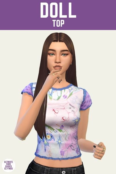 This is a product image for the Axa 2025 cc collection for The Sims 4. This image has a purple bar at the top the text "Doll Top" and below is a sim with long brown hair. They are wearing a t-shirt in blue, pink and purple with random designs like a moth and a face and flowers. 