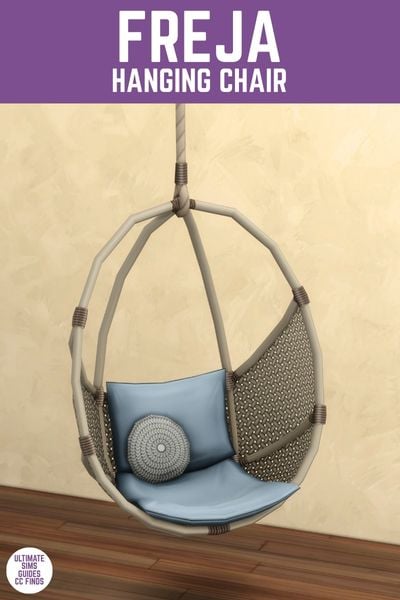 This image has a purple bar at the top with white text that reads "Freja Hanging Chair" and below is an egg chair hanging from a rope with a blue cushion 
