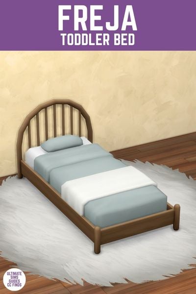 This image has a purple bar at the top with white text that reads "Freja Toddler Bed" and below is a rounded headboard toddler bed with blue blankets. 