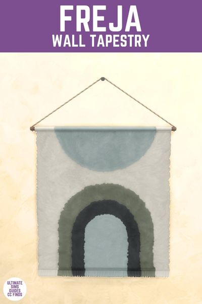 This image has a purple bar at the top with white text that reads "Freja Wall Tapestry" and below is a wall with a rectangle tapestry with blue deisgns 